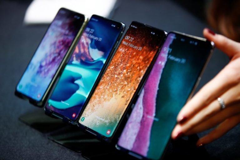 A Samsung Employee Arranges The New Samsung Galaxy S10e, S10, S10+ And The Samsung Galaxy S10 5G Smartphones At A Press Event In London