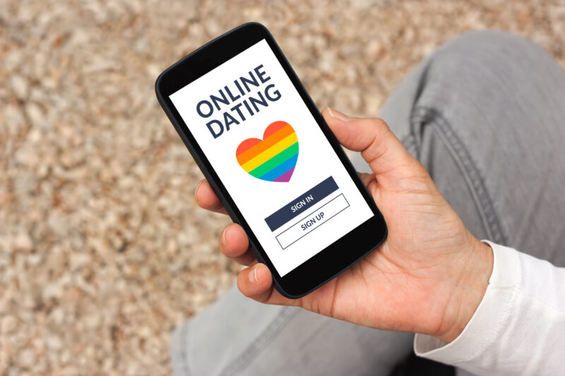 Hand,holding,smart,phone,with,lgbt,dating,app,concept,on