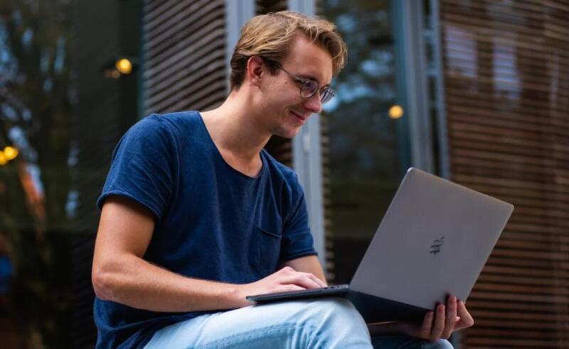 Man Holding Macbook